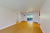 Located on Meadowbrook Circle in Fulton, NY, this single-floor, 2-bedroom, 1-bathroom unit offers a clean, functional layout with a cohesive design throughout. Light-toned hardwood-style flooring extends across the entire unit, creating a warm and consistent aesthetic from room to room.

The open living area is bright and welcoming, featuring a sliding glass door that provides direct access to an outdoor space and allows generous natural light to fill the room. A wall-mounted air conditioning unit and baseboard heating offer year-round climate control.

The kitchen is equipped with warm oak cabinetry, white appliances including a range, dishwasher, and refrigerator, along with a stainless steel sink and ample counter space — delivering a practical and efficient cooking environment.

Both bedrooms are well-proportioned and feature windows with blinds that bring in natural light and outdoor views. The primary bedroom offers a comfortable, private retreat. Each room includes baseboard heating, maintaining consistent comfort throughout.

The full bathroom is cleanly appointed with a tub-shower combination, a white vanity with a mirrored medicine cabinet, and matching fixtures, presenting a tidy and functional space. Additional utility rooms provide practical storage and mechanical access, rounding out this well-organized unit.