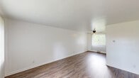 Located at 275 North Ave in Washington, PA, this multi-floor home offers a practical and functional layout spread across three levels. The main living area features rich hardwood-style flooring, bright white walls, and a ceiling fan, with a large sliding glass door that draws in natural light and offers outdoor views. A staircase with a wooden railing connects the main floor to the upper and lower levels seamlessly.

The kitchen is efficiently designed with white cabinetry, marble-pattern countertops, a stainless steel sink, and a charming wood-framed glass door that provides additional natural light and backyard access. The hardwood-style flooring continues throughout this space, adding cohesion to the design.

Upstairs, two carpeted bedrooms provide comfortable retreats. The primary bedroom is generously sized and includes a ceiling fan and closet, while the second bedroom features a window with pleasant outdoor views. A hallway connects the bedrooms to the shared full bathroom, which includes a clean white tub/shower surround and a window overlooking greenery.

The basement level offers additional utility space with tiled flooring, exposed ceiling infrastructure, and a separate utility room, providing practical storage or workspace potential.