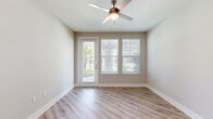 Located at 2175 Easton Loop in Kissimmee, FL, this well-appointed single-floor home offers two bedrooms, two full bathrooms, and a thoughtfully designed open-concept layout. Light wood-look flooring flows consistently throughout the entire home, lending a clean and cohesive aesthetic.

The kitchen is a standout feature, showcasing gray shaker-style cabinetry, white quartz countertops, a classic subway tile backsplash, and a central island with pendant lighting overhead. Stainless steel appliances — including a refrigerator, range, microwave, and dishwasher — complete this functional and stylish space.

The living room is bright and airy, featuring a ceiling fan, large windows with blinds, and a glass door that invites natural light while providing outdoor views of the surrounding neighborhood.

The spacious primary bedroom includes a ceiling fan and closet, while the second bedroom also benefits from natural light through dual windows. Both bedrooms are finished with the same warm wood-look flooring. Two dedicated closets provide ample storage throughout the home.

Both bathrooms are finished consistently, featuring gray shaker vanities with white countertops, tub-shower combinations with tile surrounds, and chrome fixtures. The neutral color palette and modern finishes create a clean, move-in-ready environment throughout this inviting Kissimmee home.