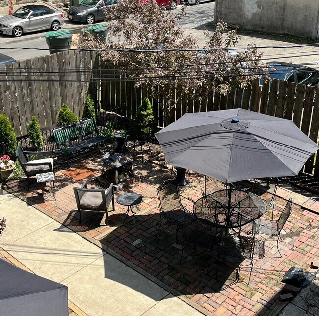 Fenced yard with 2 large patio areas, tables/chairs, firepit, nicely landscaped,space for the gril - 830 Park St