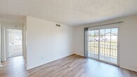 Located at 10321 Briar Hollow Dr in Saint Louis, MO, this one-bedroom, one-bathroom unit offers a well-organized, single-floor layout designed for comfortable everyday living. The living room is bright and open, showcasing light hardwood-style flooring, crisp white walls, and a textured ceiling. A large sliding glass door floods the space with natural light and provides access to a private balcony with outdoor views. A pendant light fixture adds a modern touch near the dining area. The kitchen is clean and functional, featuring white cabinetry with black hardware, white countertops, a stainless undermount sink with a black faucet, and black appliances including a refrigerator and range. A window above the sink brings in additional natural light. The bedroom is a comfortable retreat with plush carpeting, a large window overlooking the outdoors, and two closets — including a spacious walk-in closet with built-in shelving, offering generous storage. The full bathroom includes a tub-shower combination, a toilet, a vanity, and an overhead storage cabinet. A connecting hallway ties the layout together efficiently, creating a cohesive and practical living space throughout.