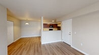 Located at 11103 W Sixth Ave in Airway Heights, WA, this single-floor unit offers a functional and comfortable layout with a clean, modern aesthetic throughout. The open-concept living and dining area is finished with light-toned luxury vinyl plank flooring, neutral walls, and a pendant light fixture that adds a warm, welcoming ambiance. Sliding glass doors lead to an outdoor area, allowing natural light to fill the living space.

The kitchen is a standout feature, showcasing rich dark cabinetry, light granite-style countertops, and black appliances including a refrigerator, stove, microwave, and dishwasher. A peninsula with pendant lighting connects the kitchen to the living area, creating an ideal space for everyday use.

The bedrooms are finished with plush carpet and neutral wall tones, providing a comfortable retreat. Each room includes closet storage and windows that bring in natural light. The bathroom is well-equipped with a full tub-shower combination, a granite-topped vanity with a single sink, and a large mirror with overhead lighting.

Overall, the unit presents a practical and neatly finished living space with consistent design choices, making it a well-rounded residence in the Airway Heights community.