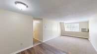 Located at 59 Mill Pond Rd in Broad Brook, CT, this two-bedroom, one-bathroom residence offers a practical and comfortable single-floor layout. The interior is finished with a combination of dark hardwood-style flooring in the entry and kitchen areas, transitioning to neutral wall-to-wall carpeting throughout the living and bedroom spaces. Textured ceilings are consistent throughout the home, lending a classic character to each room.

The kitchen features warm wood-toned cabinetry and a built-in sink, offering a functional and efficient cooking space. A connecting hallway provides access to the main living area, which is bright and open, with a window offering views of the surrounding greenery and a baseboard heating system along the exterior wall. The generously sized primary bedroom includes a dedicated closet and natural light from a window with outdoor views, while the second bedroom is equally well-proportioned with its own carpeted floor and baseboard heat.

The full bathroom is cleanly finished with white cabinetry, a single vanity with a mirror, a tub-shower combination, and wood-style flooring. Multiple hallway closets and additional storage spaces provide practical organization throughout. The overall ambiance is clean, neutral, and move-in ready.