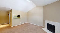 Located at 3700 Watonga Blvd in Houston, TX, this single-story, one-bedroom, one-bathroom home offers a well-organized layout across a compact yet efficiently designed floor plan. The living room is an immediate highlight, featuring dramatic vaulted ceilings that lend an open, airy feel to the space. A white brick wood-burning fireplace serves as a focal point, flanked by a large window that invites natural light and exterior views. Soft carpeting runs throughout the main living areas, contributing to a warm and comfortable ambiance. The living area flows seamlessly into the dining space, which connects to the kitchen via a convenient pass-through window. The kitchen features tile backsplash and ample cabinetry, complemented by a dedicated pantry for additional storage. The spacious primary bedroom is generously sized, equipped with a ceiling fan with light fixture, a wide closet with a rod and shelf system, and a window offering natural light. A second closet provides extra storage elsewhere in the home. The bathroom includes a full tub and shower combination. The entry area features hard flooring at the front door, transitioning to carpet throughout the rest of the home. Two closets round out the functional storage options in this well-appointed Houston residence.