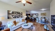 This contemporary apartment offers 940 square feet of thoughtfully designed living space. The open-concept floor plan seamlessly integrates the living, dining, and kitchen areas, creating a spacious feel. The gourmet kitchen boasts dark wood cabinetry, stainless steel appliances, and granite countertops, with a convenient breakfast bar for casual dining.

Both bedrooms feature large windows that flood the spaces with natural light, while plush carpeting adds comfort underfoot. The primary bedroom, measuring 150 square feet, provides ample space for relaxation. Two full bathrooms offer modern fixtures and finishes, including one with a shower/tub combination.

Additional amenities include an in-unit laundry room for convenience, and an attached single-car garage. The living room showcases hardwood flooring and is adorned with contemporary artwork, creating a stylish ambiance. Neutral wall colors throughout provide a versatile backdrop for personal decor preferences.

Located at 111 Creekline Pl in Greenville, SC, this single-story apartment combines modern comfort with practical living, ideal for those seeking a well-appointed home in a desirable location.