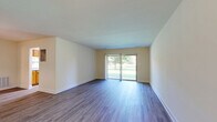 Located at 3901 Noyes Circle in Randallstown, Maryland, this single-floor, 2-bedroom, 2-bathroom home offers a practical and comfortable layout with consistent design details throughout. The open living and dining area is finished with durable wood-style flooring, neutral walls, and a pendant light fixture that anchors the dining space, creating a bright and welcoming atmosphere. The kitchen is well-appointed with warm honey-toned wood cabinetry lining both sides of the galley-style layout, granite-look countertops, white appliances including a coil-top range and refrigerator, an overhead range hood, and a skylight-style ceiling fixture that brings in additional light. A window at the far end of the kitchen adds natural brightness to the space. The spacious primary bedroom features dual sliding closet doors offering generous storage, complemented by a walk-in closet outfitted with built-in shelving and dual hanging rods. The second bedroom is well-sized with a window and wood-style flooring. Both bathrooms are finished with tile flooring and warm-toned vanities; one includes a shower-tub combo with white tile surround. The home's clean, neutral palette and wood-style flooring throughout create a cohesive and move-in-ready feel.
