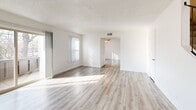 This two-story, two-bedroom, two-bathroom home in Sacramento, CA offers a well-organized layout spread across two floors of comparable size. The main level features a bright, open living room with light wood-style flooring, a textured ceiling, and a sliding glass door that opens to a balcony with views of mature surrounding trees. The living area flows naturally into a dedicated dining room and a galley-style kitchen outfitted with white cabinetry, granite-look countertops, a full suite of white appliances, and a stainless steel sink. A pantry and utility room add practical storage on this level.

Upstairs, the two bedrooms offer a comfortable retreat. The generously sized primary bedroom features wood-style flooring, vertical blinds, a ceiling fan, and a private closet. The second bedroom is carpeted and includes dual closets, providing ample storage. Both bathrooms are finished with wood-look flooring, white vanity cabinetry, granite-look countertops, and clean, neutral finishes. A second balcony accessible from the upper level extends the living space outdoors. With five closets total distributed throughout, the home offers exceptional storage capacity. The clean, neutral palette and consistent finishes throughout create a bright, cohesive atmosphere.