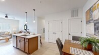 This well-designed 2-bedroom, 2-bathroom single-floor residence at 3402 S Webster St in Kokomo, Indiana, offers a thoughtful layout with modern finishes throughout. Light wood-tone flooring flows seamlessly across the entire space, creating a bright and cohesive aesthetic.

The open-concept kitchen is a standout feature, showcasing warm wood cabinetry with matte black hardware, white quartz countertops, and a full suite of stainless steel appliances including a refrigerator, range, and over-the-range microwave. A kitchen island with a built-in sink and pendant lighting above serves as both a functional workspace and casual dining area, opening directly into the dining space and living room.

The living room is airy and welcoming, bathed in natural light from large windows and outfitted with a ceiling fan. The primary bedroom is generously sized, featuring multiple windows, a ceiling fan, and ample natural light. The second bedroom provides comfortable accommodations with its own window.

Both bathrooms maintain the same modern design language, each featuring warm wood vanities with white countertops, framed mirrors, and stylish matte black fixtures. The space also includes a dedicated closet for additional storage. Clean white walls and recessed lighting throughout contribute to the home's fresh, contemporary character.