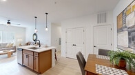 This well-designed 2-bedroom, 2-bathroom single-floor residence at 3402 S Webster St in Kokomo, Indiana, offers a thoughtful layout with modern finishes throughout. Light wood-tone flooring flows seamlessly across the entire space, creating a bright and cohesive aesthetic.

The open-concept kitchen is a standout feature, showcasing warm wood cabinetry with matte black hardware, white quartz countertops, and a full suite of stainless steel appliances including a refrigerator, range, and over-the-range microwave. A kitchen island with a built-in sink and pendant lighting above serves as both a functional workspace and casual dining area, opening directly into the dining space and living room.

The living room is airy and welcoming, bathed in natural light from large windows and outfitted with a ceiling fan. The primary bedroom is generously sized, featuring multiple windows, a ceiling fan, and ample natural light. The second bedroom provides comfortable accommodations with its own window.

Both bathrooms maintain the same modern design language, each featuring warm wood vanities with white countertops, framed mirrors, and stylish matte black fixtures. The space also includes a dedicated closet for additional storage. Clean white walls and recessed lighting throughout contribute to the home's fresh, contemporary character.