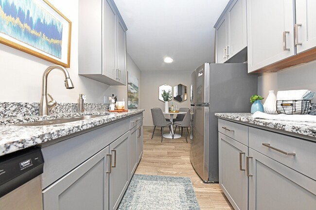 Kitchen with granite counters and modern cabinetry - Kinley at the Park