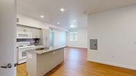 Located at 1510 Valentia St in Denver, CO, this single-floor residence offers four bedrooms and two full bathrooms in a clean, modern layout. The open-concept kitchen and living area forms the heart of the home, featuring granite countertops, a peninsula with a stainless steel sink, gray shaker-style cabinetry, a dark tile backsplash, and white appliances including an electric range and microwave. Light hardwood-style flooring runs throughout the main living areas, complemented by recessed lighting that keeps the space bright and welcoming. The living area is open and airy, with a window providing natural light. The four bedrooms are carpeted and finished with crisp white walls and blinds-covered windows. One bathroom features a full tub/shower combo and granite vanity, with direct access to a dedicated walk-in closet, while the second bathroom also includes a granite-topped vanity with a large mirror. Both bathrooms maintain the same clean, consistent finishes found throughout the home. A dedicated closet provides additional storage. The neutral palette, consistent finishes, and practical floor plan make this a versatile and comfortable residence in the desirable Park Hill neighborhood of Denver.