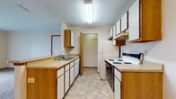 Located at 3675 Cross Ridge Ln in Canal Winchester, Ohio, this single-floor residence offers a practical and well-organized layout suitable for comfortable everyday living. The galley-style kitchen is equipped with white cabinetry accented by warm wood trim, a double-basin sink, a full suite of white appliances including a coil-top electric range, dishwasher, and refrigerator, and generous counter space. A walk-in closet or pantry is conveniently accessible directly from the kitchen. The kitchen opens toward the living area via a peninsula-style half-wall, creating an open, connected feel between the cooking and living spaces. The living room is carpeted and features a large sliding glass door dressed with vertical blinds, allowing natural light to fill the space and providing access to the outdoors. The bedrooms are carpeted and offer a neutral, clean aesthetic with windows that bring in natural light. The full bathroom includes a single-sink vanity with wood-trimmed mirror, a standard toilet, and a tub-shower combination. Tile-style flooring carries through the kitchen, bathroom, and entryway areas, complementing the carpet found throughout the rest of the home. Overall, the space presents a clean, functional, and move-in-ready environment.