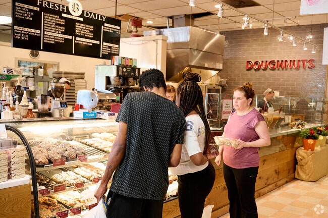 Shoppers try to decide which doughnuts to purchase in the Lancaster Dutch Market in Germantown, Maryland.