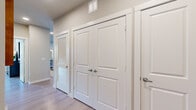 This thoughtfully designed 2-bedroom, 3-bathroom single-floor residence offers a comfortable and functional layout with contemporary finishes throughout. The open-concept living, dining, and kitchen area serves as the heart of the home, where light wood-tone flooring and recessed lighting create a bright, welcoming atmosphere. The kitchen is equipped with stainless steel appliances including a French door refrigerator, rich dark cabinetry, granite countertops, and a large island with bar seating — ideal for both cooking and entertaining. The adjacent dining area comfortably accommodates a full dining set. The spacious primary bedroom features natural light from large windows, hardwood-style flooring, and a dedicated walk-in closet with wire shelving systems for organized storage. A second bedroom offers versatility, easily serving as a guest room or home office, and is bathed in natural light from multiple windows. The bathrooms are finished with granite-topped dark vanities, tile shower surrounds, and modern fixtures. A hallway with double doors provides additional storage and closet access. Throughout the residence, neutral wall tones, clean trim work, and light flooring tie the design together cohesively, creating an inviting and functional living environment.