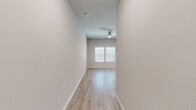 Located at 27604 Beach Ball Dr in Katy, TX, this two-story home offers a clean, modern aesthetic with light-toned luxury vinyl plank flooring and neutral warm-beige walls carried consistently throughout. The ground floor houses the open-concept kitchen and living area alongside an attached garage. The kitchen is well-appointed with white shaker cabinetry, granite countertops, a subway tile backsplash, and stainless steel appliances, creating a bright and functional space. The attached garage features an automatic opener and offers generous storage capacity. Upstairs, the more spacious second floor accommodates all three bedrooms, two bathrooms, and a dedicated closet. The generously sized primary bedroom includes a ceiling fan, dual windows for natural light, and access to a walk-in closet with built-in shelving and hanging rods. The primary bathroom is a standout feature, boasting a dual-sink vanity with white cabinetry, a glass-enclosed walk-in shower with floor-to-ceiling tile, and light wood-look flooring that carries the home's cohesive design language. The additional bedrooms are bright and well-proportioned, each benefiting from natural light through blinds-fitted windows. Throughout the home, clean white trim and neutral tones create an inviting, move-in ready atmosphere.