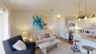 Located at 3280 Mill Run Dr in Hilliard, Ohio, this single-floor residence offers a thoughtfully designed layout that balances comfort and functionality. The living room is a welcoming space highlighted by vaulted ceilings, soft neutral tones, and plush carpeting. Large windows allow natural light to pour in, offering views to the outdoors, and the open feel is complemented by the flowing connection to the kitchen and dining area.

The kitchen is well-appointed with white cabinetry, granite-look countertops, and a full suite of appliances including a refrigerator, range, and built-in microwave. A peninsula with a sink provides additional workspace and casual seating. A built-in desk area adjacent to the kitchen adds a convenient home office nook with open shelving.

The bedroom is a serene retreat featuring vaulted ceilings, plush carpet, and a window that brings in natural light. It connects directly to a full bathroom, which includes a granite-topped vanity with white cabinetry, a tiled tub-shower combination, and tile flooring. The overall design throughout the space features warm, neutral finishes that create a cohesive and inviting ambiance, making this a comfortable and practical single-level home.