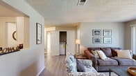 Located at 200 Lakeland Dr in Hot Springs, Arkansas, this single-floor, 3-bedroom, 2-bathroom home offers a well-organized layout designed for comfortable everyday living. The combined living and dining area serves as the heart of the home, featuring warm wood-look flooring, neutral walls, and a sliding glass door that invites natural light and provides outdoor access. A convenient in-unit laundry closet is tucked seamlessly into the living area.

The galley-style kitchen is efficiently designed with ample white cabinetry, dark granite-look countertops, and black appliances, including a refrigerator, range, and built-in microwave. Light flooring ties the space together for a clean, cohesive look.

The generously sized primary bedroom features plush carpeting, a large window with outdoor views, and access to a dedicated walk-in closet outfitted with wire shelving for organized storage. Two additional bedrooms, also carpeted and well-lit, offer flexibility for guests or a home office. Both bathrooms are finished with white vanity cabinetry, solid countertops, and bright vanity lighting, creating a clean and functional aesthetic. A hallway connects all rooms, ensuring a smooth and logical flow throughout this thoughtfully arranged home.