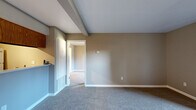 Located at 3525 San Clemente Ave in Modesto, CA, this single-story, one-bedroom, one-bathroom home offers a thoughtfully organized floor plan that maximizes its compact footprint. The living room serves as the heart of the space, highlighted by a tile-surround fireplace with a glass-front insert and a sliding glass door that opens to an outdoor patio area, filling the room with natural light. Soft carpeting and neutral taupe walls create a warm, inviting atmosphere throughout the main living area.

The kitchen is efficiently designed with warm oak cabinetry extending to the ceiling for ample storage, white appliances including a range, over-the-range microwave, and refrigerator, and durable hardwood-style flooring. A raised pass-through bar connects the kitchen to the living area, enhancing the open feel. In-unit washer and dryer connections are conveniently located nearby.

The bedroom is a well-proportioned retreat with plush carpeting, a large window that brings in outdoor views and natural light, and access to a dedicated closet. The bathroom features a wide vanity with a white countertop, wood cabinetry, chrome fixtures, and a large mirror. Exposed ceiling beams add a subtle architectural character to select areas of the home.