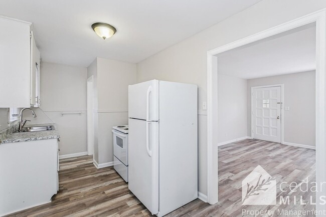 Building Photo - Updated, clean unit, with LARGE basement for storage!