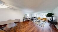 Located at 15 Poncetta Dr in Daly City, CA, this well-appointed one-bedroom, one-bathroom residence offers a thoughtfully organized single-level layout. Rich hardwood flooring flows throughout the unit, lending warmth and continuity to every room.

The combined living and dining area forms the heart of the home, offering an open, airy feel. The living space is brightened by a large window dressed with vertical blinds, allowing ample natural light. The dining area provides a defined space for meals, complemented by clean white walls and a textured ceiling.

The kitchen features white shaker-style cabinetry, light stone countertops, a stainless steel refrigerator, and a gas range, offering both functionality and a clean aesthetic. Hardwood flooring continues into this space, maintaining a cohesive look.

The bedroom is a comfortable retreat, benefiting from a sizable window that invites natural light and offers outdoor views. Its layout accommodates essential furnishings with ease.

The bathroom includes a full-size soaking tub with an overhead shower, finished with light speckled wall surrounds and chrome fixtures, presenting a clean and practical design.

A connecting hallway ties all rooms together efficiently, completing this well-structured and move-in-ready Daly City residence.