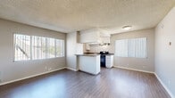 Located at 890 S Rosemead Blvd in Pasadena, CA, this 2-bedroom, 1-bathroom unit offers a functional and well-appointed single-floor layout. The open-concept living and dining area features wood-style laminate flooring, a textured ceiling, and large windows with vertical blinds that allow abundant natural light to fill the space. The kitchen is equipped with white cabinetry, dark granite countertops, a gas range, dishwasher, and refrigerator — all in black — complemented by an over-range ventilation hood and a peninsula that connects seamlessly to the living area. Both bedrooms are carpeted and receive natural light through vertical-blind windows. The primary bedroom includes mirrored sliding closet doors, adding a sense of depth and brightness to the room. The second bedroom also features a window unit for climate control. Three closets throughout the unit provide generous storage. The bathroom is finished with stone-tile flooring, a white vanity with granite countertop, a large mirror, and a tub-shower combination. A connecting hallway ties the layout together efficiently. The unit's neutral color palette and practical finishes create a clean, move-in-ready atmosphere.