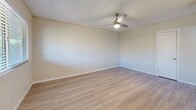 Located at 3765 N Campbell Ave in Tucson, AZ, this 2-bedroom, 1-bathroom unit offers a practical and updated single-floor layout. Light wood-style flooring runs throughout, creating a cohesive and bright feel across all rooms.

The combined kitchen and living area serves as the heart of the unit. The kitchen is well-appointed with white shaker cabinetry, a subway tile backsplash, light countertops, and a full suite of stainless steel appliances including a refrigerator, dishwasher, over-the-range microwave, and gas range. A circular pendant light and recessed flush fixture illuminate the space, and a dining area with a window offering natural light sits just adjacent.

The living room features painted concrete block walls, light flooring, a ceiling fan, and a window that brings in natural light. Both bedrooms are modest in scale, with the primary offering a spacious closet with sliding doors. Each bedroom includes wall sconce lighting, textured ceilings, and access via clean white shaker-style interior doors.

The bathroom is neatly finished with a white vanity, quartz-style countertop, undermount sink, and framed mirrors above. A hallway connects the main living areas to the bedrooms and bathroom, keeping the layout functional and straightforward.