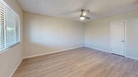 Located at 3765 N Campbell Ave in Tucson, AZ, this 2-bedroom, 1-bathroom unit offers a practical and updated single-floor layout. Light wood-style flooring runs throughout, creating a cohesive and bright feel across all rooms.

The combined kitchen and living area serves as the heart of the unit. The kitchen is well-appointed with white shaker cabinetry, a subway tile backsplash, light countertops, and a full suite of stainless steel appliances including a refrigerator, dishwasher, over-the-range microwave, and gas range. A circular pendant light and recessed flush fixture illuminate the space, and a dining area with a window offering natural light sits just adjacent.

The living room features painted concrete block walls, light flooring, a ceiling fan, and a window that brings in natural light. Both bedrooms are modest in scale, with the primary offering a spacious closet with sliding doors. Each bedroom includes wall sconce lighting, textured ceilings, and access via clean white shaker-style interior doors.

The bathroom is neatly finished with a white vanity, quartz-style countertop, undermount sink, and framed mirrors above. A hallway connects the main living areas to the bedrooms and bathroom, keeping the layout functional and straightforward.