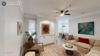 Located in Chapel Hill, NC, this well-appointed single-floor home offers four bedrooms and three bathrooms within a thoughtfully designed layout. The combined living and dining area serves as the heart of the home, featuring light wood-look flooring, crown molding, and a ceiling fan overhead. A distinctive arched built-in niche with cabinetry and a granite top adds architectural character, while arched passageways connect seamlessly to the dining space, which is bathed in natural light from multiple large windows and anchored by a statement pendant light. The kitchen is outfitted with white shaker cabinetry, granite countertops, a subway tile backsplash, stainless steel appliances, and a double-basin sink — a functional and stylish space for everyday use. The primary bedroom is generously proportioned with a ceiling fan and easy access to closet space. All three bathrooms feature granite vanity tops and matte black fixtures, with tub-shower combinations finished in clean white tile. A covered outdoor porch with wood-beam ceiling detailing and an arched opening offers a relaxing retreat with views of the surrounding greenery — accessible directly from one of the bedrooms. In-unit laundry access is also provided, rounding out this complete and comfortable home.
