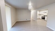 Located on Bethany Ct SE in Lacey, Washington, this single-floor, 2-bedroom, 2-bathroom home offers a clean, modern aesthetic throughout. Light luxury vinyl plank flooring flows seamlessly across every room, complementing the neutral gray and beige tones of the freshly painted walls and crisp white trim.

The open-concept living room is bright and welcoming, highlighted by a tile-surround fireplace and a sliding glass door that fills the space with natural light. The kitchen is well-appointed with white shaker-style cabinetry, light marble-look countertops, and a full suite of stainless steel appliances including a refrigerator, electric range, and dishwasher. A dedicated laundry area with a full-size washer and dryer is conveniently accessible from the kitchen.

The primary bedroom is generously sized, offering ample room for furnishings, while the second bedroom also benefits from natural light through a window with blinds. Both bedrooms include closet space. The two bathrooms are outfitted with white vanities and full tub-shower combinations with brushed nickel fixtures. Three closets throughout the home provide excellent storage. The layout is efficient and functional, making excellent use of the available square footage.