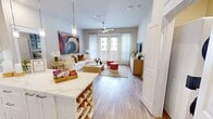 This 1,000 sq ft, single-floor apartment at 125 Prairie Pkwy in Katy, TX features 2 bedrooms, 2 bathrooms, and a well-planned layout that balances comfort and modern style. The open-concept kitchen and living area is a standout, boasting white shaker cabinetry, quartz countertops, a gray subway tile backsplash, stainless steel appliances, under-cabinet lighting, and a large center island with seating for casual dining. The living room offers hardwood-style flooring, a ceiling fan, and French doors that invite abundant natural light. The primary bedroom spans 180 sq ft and features a ceiling fan, large window with sheer draping, and access to a walk-in closet with wire shelving systems. The second bedroom mirrors the calm, neutral aesthetic. Both bathrooms are finished with white quartz vanities and marble-style tile surrounds — one featuring a soaking tub and the other a glass-enclosed walk-in shower. Two closets provide ample storage throughout. A connecting hallway ties each room together in a cohesive, clean design. The overall ambiance is bright, modern, and move-in ready.