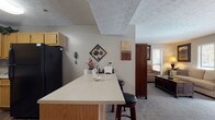Located at 500 Maxham Rd in Austell, Georgia, this single-floor residence offers a well-organized and comfortable layout designed for everyday living. The kitchen is outfitted with warm oak cabinetry, black appliances including a refrigerator, dishwasher, and range, and durable wood-look flooring. A peninsula with a light countertop and bar seating connects the kitchen to the rest of the living space, making it ideal for casual dining or entertaining. Adjacent to the kitchen, the dining area features a pendant light fixture and a window that brings in natural light, creating a pleasant setting for meals. The living room is carpeted and lined with multiple windows, filling the space with natural light and providing a bright, relaxed atmosphere with access to an exterior door. The bedrooms are carpeted and well-proportioned, each featuring windows with blinds for privacy and natural light. The primary bedroom includes a walk-in closet with built-in shelving and hanging space. The bathrooms feature oak vanities with light countertops, lighted mirrors, and wood-look tile flooring. Throughout the residence, a neutral color palette and textured ceilings contribute to a cohesive and understated aesthetic.