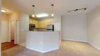 This single-floor residence in Gallatin, Tennessee offers a well-designed open-concept layout that seamlessly connects the kitchen and living areas. The kitchen is outfitted with light maple cabinetry, granite countertops, and stainless steel appliances, including a refrigerator, range, and over-the-range microwave. Light tile flooring runs throughout the kitchen, complemented by a peninsula with a granite overhang that provides a natural transition into the living space. Pendant lights and track lighting illuminate the kitchen and adjoining areas effectively.

The living area is generously sized, featuring neutral-toned carpet, a ceiling fan, and access to an outdoor balcony through a set of French-style doors that bring in ample natural light. Additional rooms include well-proportioned bedrooms with carpet flooring, ceiling fans, and windows offering exterior views. A bathroom with tile flooring provides functional utility. A dedicated laundry area houses a full-sized washer and dryer alongside a water heater, adding everyday convenience. The overall color palette of warm beige tones throughout creates a cohesive and inviting atmosphere.