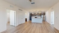 Located at 101 Mirano Way in Nokomis, Florida, this well-appointed 2-bedroom, 2-bathroom single-story home offers a thoughtfully designed open-concept layout. Light wood-style flooring flows consistently throughout, creating a bright and cohesive aesthetic across every room.

The kitchen serves as a central focal point, featuring gray shaker-style cabinetry, crisp white quartz countertops, a central island with a stainless steel undermount sink, and a full suite of stainless steel appliances including a range, microwave, dishwasher, and refrigerator. Pendant lighting above the island adds a modern touch, while the open layout connects seamlessly to the spacious living area, which is equipped with a ceiling fan.

The primary bedroom is generously sized and includes dedicated closet space, while the second bedroom benefits from natural light through dual windows and its own ceiling fan. Both bathrooms are finished with gray vanity cabinetry and white countertops; one features a tub-shower combination and the other offers a walk-in shower setup. A dedicated laundry room with in-unit washer and dryer adds everyday convenience. The overall design is clean, modern, and move-in ready.