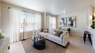 This thoughtfully designed 1-bedroom, 1-bathroom residence offers a cohesive single-level layout that balances comfort and functionality. The open-concept living and dining area serves as the heart of the home, featuring light wood-style flooring, neutral warm-toned walls, and multiple windows dressed with blinds and sheer curtains that invite an abundance of natural light. The dining space accommodates a full-sized rustic wood table with black chairs, complemented by a pair of large-scale abstract art pieces that add a contemporary flair.

The kitchen is outfitted with rich dark wood cabinetry, crisp white countertops, and a full suite of stainless steel appliances — including a refrigerator, electric range, built-in microwave, and dishwasher. Track lighting above and pendant fixtures near the sink enhance the workspace, while the light flooring ties the kitchen seamlessly to the main living area.

The bedroom is a serene retreat featuring carpet flooring, multiple windows that bring in natural light, and ample space for a queen-sized bed and accompanying furniture. The full bathroom features light wood-look tile flooring, a dark wood vanity with white countertop, and a shower-tub combination with a stylish patterned curtain, creating a clean and functional space.