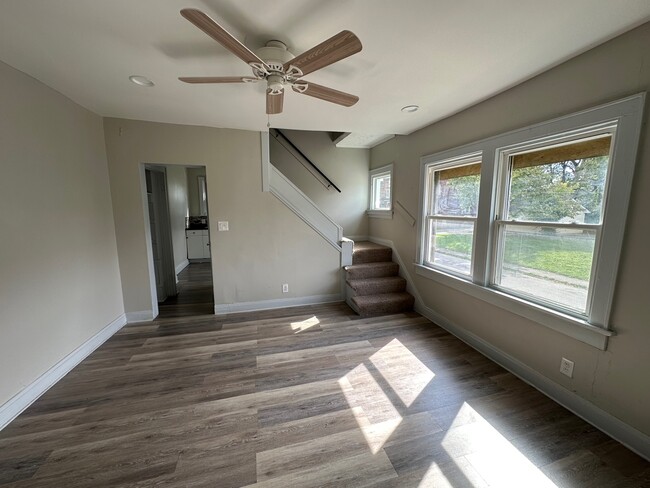 Dining room with ceiling fan and two large windows. - 738 Seymour Ave