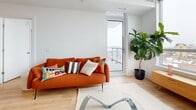 Located at 929 Richmond Rd in Ottawa's vibrant Westboro neighbourhood, this well-designed one-bedroom, one-bathroom unit offers a thoughtful layout across a single floor. The open-concept kitchen and living room serve as the heart of the space, bathed in natural light from large floor-to-ceiling windows that frame sweeping city views. The kitchen is outfitted with crisp white cabinetry, a penny-tile backsplash, stainless steel appliances including a gas range, dishwasher, and refrigerator, and a clean white countertop that flows into a casual dining area. Light hardwood flooring runs throughout, adding warmth to the contemporary palette. The living area is generous and bright, with direct access to a private balcony through a full-height glass door. The bedroom benefits from expansive windows that fill the room with natural light and offer additional city views, complemented by a dedicated closet for storage. The bathroom features classic white hexagonal floor tiling, a pedestal sink, and a clean, minimal aesthetic. A hallway connects all rooms efficiently, maintaining a smooth and functional flow. The overall ambiance is modern, airy, and welcoming — an ideal urban residence in one of Ottawa's most sought-after communities.