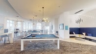This expansive amenity lounge spans a generous single floor, offering a thoughtfully designed social space with a vibrant, contemporary aesthetic. The open layout accommodates multiple distinct activity zones, anchored by two full-sized billiard tables set atop richly patterned area rugs over polished flooring. Sputnik-style pendant chandeliers cast warm, ambient light throughout, complementing the crisp white walls and high ceilings that lend the space an airy, upscale feel.

A fully equipped kitchen area features bold turquoise cabinetry with a striking high-gloss backsplash, built-in appliances, and a sleek island with bar seating — ideal for entertaining. Adjacent to the game area, a lounge nook showcases a vibrant blue sectional sofa, ocean-inspired wall art, and a tufted ottoman, creating an inviting retreat.

Floor-to-ceiling windows wrap around a curved corner seating area, flooding the space with natural light and offering sweeping panoramic city views. Sheer white curtains frame the windows elegantly. A separate media lounge features a dramatic gradient blue accent wall with dual mounted flat-screen televisions. Throughout, the cohesive blue-and-white color palette, sculptural lighting, and curated artwork contribute to a polished, resort-style atmosphere.