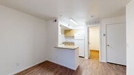 Located at 4415 S 28th St in Phoenix, AZ, this one-bedroom, one-bathroom unit offers a well-organized single-floor layout designed for practical, everyday living. Wood-style flooring runs throughout the entire space, providing a warm and cohesive aesthetic from room to room.

The living room is bright and open, with a front entry door and a sliding glass door that opens to an outdoor balcony, allowing natural light to filter in. The kitchen is efficiently designed with a peninsula breakfast bar that separates it from the living area, light wood cabinetry, a full-size refrigerator, an electric range, and an overhead ventilation hood — providing all essential cooking conveniences in a compact footprint.

The bedroom is a comfortably sized private retreat featuring large windows with vertical blinds that invite natural light while maintaining privacy. A dedicated closet adds practical storage to the room. The bathroom is clean and functional, equipped with a full tub-and-shower combination, a toilet, and a vanity with a wood-toned cabinet base and a dark granite-style countertop. Clean white walls and consistent flooring tie the entire unit together, creating a simple, move-in-ready living environment suited for single occupants or couples in the Phoenix area.