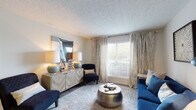 This single-floor residence in Pickerington, Ohio offers a thoughtfully designed layout with contemporary finishes and a cohesive, modern aesthetic throughout. The living room serves as the heart of the home, featuring rich hardwood-style flooring, a textured ceiling, and large windows dressed with elegant floor-to-ceiling drapes that invite abundant natural light. The space flows seamlessly into a dining area, which is conveniently adjacent to an in-unit laundry closet with full-size washer and dryer. The galley-style kitchen is well-equipped with white shaker cabinetry, granite countertops, a subway tile backsplash, stainless-steel sink, and black appliances, all set above warm wood-look flooring. The bedroom is generously sized with plush carpeting, dual windows for natural light, and a textured ceiling. A secondary room with carpeted flooring and a large window offers flexible use as a bedroom or office. The bathroom features a granite-topped vanity, a framed mirror, and a full tub-shower combination. Throughout the residence, neutral wall tones, consistent finishes, and carefully considered design details create a comfortable and functional living environment.