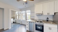 Located at 1936 N Clark Street in Chicago's vibrant Lincoln Park neighborhood, this efficiently designed unit makes excellent use of its compact footprint. The open layout seamlessly integrates the living area and kitchen, creating a cohesive and functional space. The kitchen is thoughtfully appointed with crisp white shaker cabinetry extending to the ceiling, granite countertops, a subway tile backsplash, and a full suite of stainless steel appliances including a refrigerator, dishwasher, electric range with oven, and an under-cabinet range hood. Natural light streams through multiple windows fitted with horizontal blinds, brightening the interior throughout the day. The living area features wood-style flooring in a cool gray tone, crown molding, a ceiling fan with light fixture, and a mirrored closet that adds depth and storage. The bathroom is finished in a clean, modern palette with large-format marble-look tile flooring, white subway tile surrounding the bathtub, and matte black hardware accents. A traditional radiator provides reliable heating. The overall aesthetic is clean and contemporary, with a neutral color scheme that maximizes the sense of openness throughout this well-appointed Lincoln Park residence.
