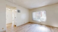 Located at 1332 S Hope St, Unit 313 in the heart of Los Angeles, this one-bedroom, one-bathroom unit offers a clean, efficient layout ideal for urban living. Light wood-style flooring runs throughout, lending warmth and continuity across every room. The combined living and dining area is bright and open, featuring multiple windows dressed with vertical blinds that allow natural light to pour in while offering views of the surrounding cityscape. A textured ceiling adds subtle character to the space. The kitchen is neatly tucked behind a partial dividing wall, outfitted with white cabinetry, white appliances including a range, and a compact footprint that makes efficient use of the available space. The bedroom is a comfortable and well-lit retreat, benefiting from two windows and a sliding-door closet for ample storage. An additional closet in the hallway provides further organizational flexibility. The bathroom is finished in a clean, all-white palette featuring a tub/shower combo with tiled surround, a window for natural ventilation, a vanity with a stone-look countertop, and light wood flooring. The overall aesthetic throughout is bright, neutral, and move-in ready, making this unit a practical and functional home in a prime Downtown Los Angeles location.