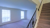 Located at 801 W Park Avenue in Lindenwold, New Jersey, this two-story property offers a well-structured layout designed for comfortable living across two distinct floors. The interior is characterized by clean, neutral finishes and an airy ambiance that creates a welcoming atmosphere throughout.

A standout architectural feature is the staircase, which is appointed with ornate wrought-iron balusters and a classic railing, adding a refined decorative element to the home's interior. The upper level showcases a vaulted ceiling that lends a sense of generous vertical space, enhancing the open feel of the area. Plush carpeting covers the upper floor, contributing to a warm and comfortable environment.

Natural light plays an important role in the character of the space. Windows positioned to draw in daylight illuminate the interior, keeping rooms bright and inviting. The walls throughout are finished in crisp, neutral tones that complement the overall clean aesthetic and provide a versatile backdrop for a variety of interior styles.

The two-floor configuration allows for clear separation between living areas, providing functional zoning within the home. Overall, the property presents a straightforward, move-in ready environment with tasteful architectural details and a light-filled, open interior that defines its character.