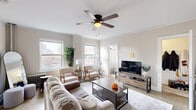 Located at 711 16th St in Milwaukee, WI, this one-bedroom, one-bathroom unit offers a thoughtfully organized layout with classic architectural details throughout. The living room serves as the heart of the space, showcasing crown molding, terrazzo flooring, and multiple windows that invite abundant natural light and frame views of the surrounding cityscape. A ceiling fan adds both style and function to the room, which comfortably accommodates a full seating arrangement and a dedicated dining area. A compact yet efficient kitchen includes a gas range, refrigerator, and butcher block countertop, providing all the essentials for everyday cooking. The bedroom is a calm, understated retreat with a window allowing natural light, terrazzo flooring, and room for a full bedroom set and a dedicated workspace. A walk-in closet provides valuable storage. The bathroom features classic white penny tile flooring and a shower-tub combination. Throughout the unit, warm neutral tones, crisp white trim, and consistent flooring create a cohesive and inviting aesthetic. A cast iron radiator and a decorative stove complement the building's character, reflecting the charm of this Milwaukee residence.