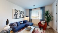 Located at 6851 N 93rd Ave in Glendale, Arizona, this well-appointed one-bedroom, one-bathroom residence offers a thoughtfully designed layout across a single floor. The open-concept kitchen and living area serves as the heart of the home, where the kitchen stands out with crisp white upper cabinetry, warm wood-toned lower cabinets, granite countertops, and a central island with seating for three. Stainless steel appliances, a matte black gooseneck faucet, and pendant lighting overhead complete the modern aesthetic. Light wood-style flooring flows throughout the main living areas, enhancing the bright, airy atmosphere. The living room offers a comfortable gathering space with a large window that brings in natural light and views of the surrounding landscape. The generously sized bedroom features plush carpet, a ceiling fan, a window with outdoor views, and a dedicated closet, providing a restful retreat. The bathroom is finished with granite countertops, wood-toned cabinetry, light flooring, and a walk-in shower. Clean white walls, recessed and pendant lighting, and consistent modern hardware tie the entire residence together, creating a cohesive and contemporary living environment.