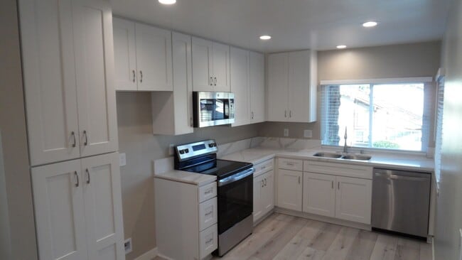 Building Photo - REMODELED 2BR; 2BA end unit condo with 1 car garage & 1 parking space