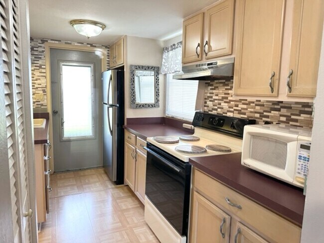 Building Photo - 55+ Community, FURNISHED 1BR/1BA CONDO IN ...