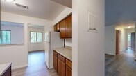 Located at 581 Lake Forest Ln in Norton Shores, Michigan, this single-floor, 3-bedroom, 2-bathroom home offers a practical and comfortable layout across its well-organized floor plan. The kitchen is equipped with warm oak cabinetry — both upper and lower — light countertops, and a full-size refrigerator, with an open sightline connecting to an adjacent living area. The home features two separate living spaces, providing flexibility for a dedicated dining area, home office, or secondary lounge. Both areas are finished with durable wood-style flooring that extends throughout the main living spaces, while the bedrooms are carpeted for added comfort. Each bedroom features windows that bring in natural light and offer views of the surrounding tree-lined landscape. The primary bedroom provides a generous footprint with ample room for standard furnishings. The two bathrooms are clean and functional, with one featuring a tiled tub-shower combination and wood-style vinyl flooring. Three hallways connect the rooms efficiently, and a dedicated closet adds to the home's storage capacity. The neutral color palette throughout creates a bright, cohesive atmosphere well-suited to a variety of interior styles.