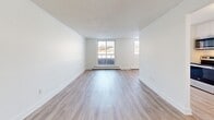 This contemporary apartment, situated at 205 Champlain Blvd in Cambridge, Ontario, offers 770 square feet of well-designed living space. The single-floor layout comprises two bedrooms, including a primary bedroom of 150 square feet, and one bathroom. The open-concept design seamlessly integrates the kitchen and living room, creating a spacious and inviting atmosphere.

Throughout the apartment, light wood-toned flooring adds warmth and continuity. Large windows in the living area and bedrooms allow ample natural light to flood the space, while offering views of the surrounding area. The crisp white walls contribute to the apartment's bright and airy ambiance.

The kitchen features modern white cabinetry, complemented by a sleek stainless steel countertop and double sink. A subway tile backsplash adds a touch of classic elegance. The bathroom boasts a clean, contemporary design with white subway tiles and a combination bathtub and shower.

Practicality is addressed with the inclusion of a closet for storage. The apartment's layout, as seen in the 3D floor plan, reveals an efficient use of space that maximizes comfort and functionality. Overall, this apartment offers a modern and comfortable living environment in a convenient Cambridge location.