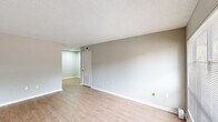 This upgraded 1-bedroom, 1-bathroom unit in Baton Rouge, Louisiana, offers a thoughtfully designed single-story layout with contemporary finishes throughout. The living area is bright and open, featuring light wood-style flooring, neutral gray walls, and a textured ceiling. A large window allows natural light to fill the space, creating a welcoming ambiance, while a private entry door adds convenience.

The kitchen is efficiently arranged with gray cabinetry accented by matte black hardware, a stainless steel sink with a matching black faucet, light marble-style countertops, and a dishwasher. An electric range with overhead ventilation completes the cooking space, making it both practical and stylish.

The bedroom is carpeted for comfort and includes a ceiling fan with a light fixture, a window with outdoor views, and access to a walk-in closet equipped with shelving and a hanging rod, providing ample storage.

The bathroom features a full tub-shower combination with clean white surrounds, complemented by matte black fixtures and a towel bar, maintaining a cohesive modern aesthetic throughout the unit.