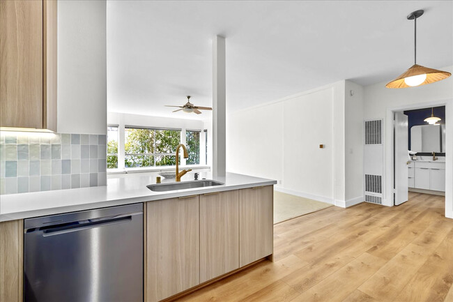 New luxury vinyl wide-plank flooring in kitchen, dining room and bathroom. - 2221 Ocean Ave